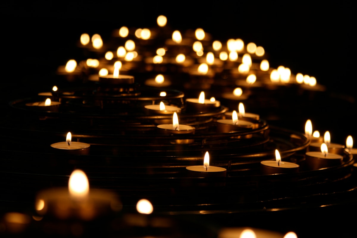 Lit candles in the dark — a memorial atmosphere