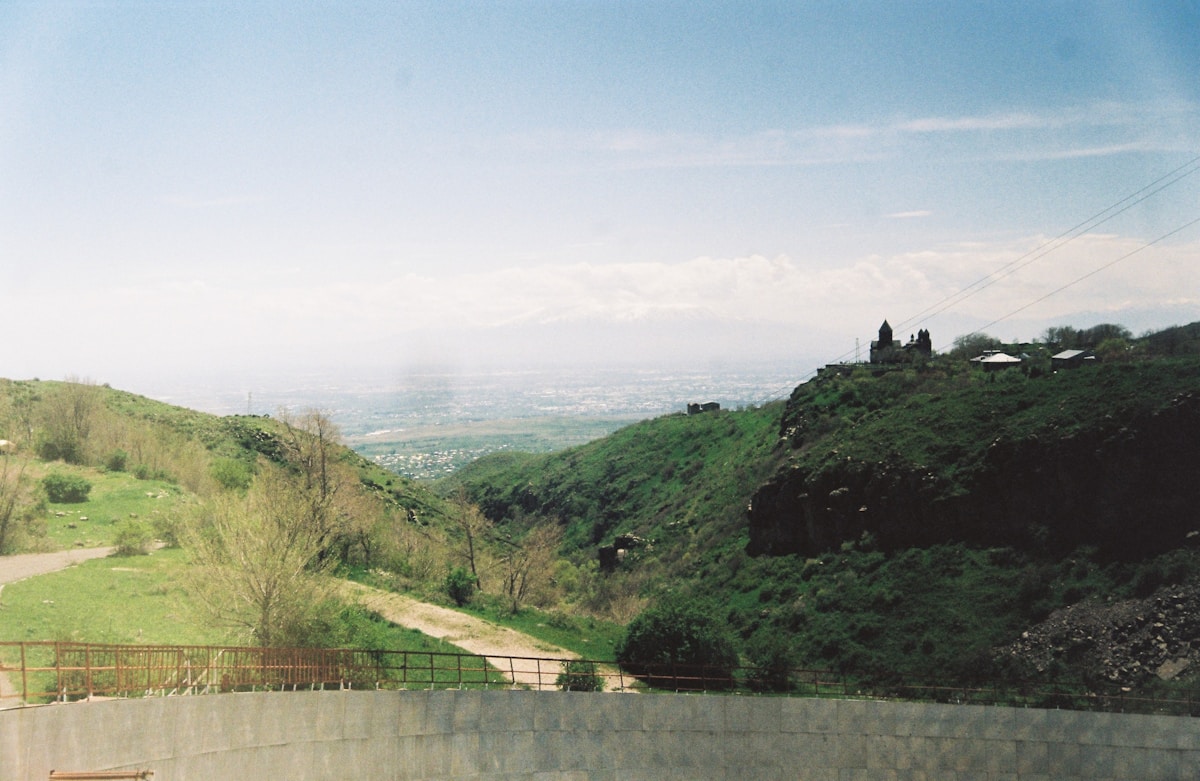 Winding road through a green valley in Armenia — road trip itinerary