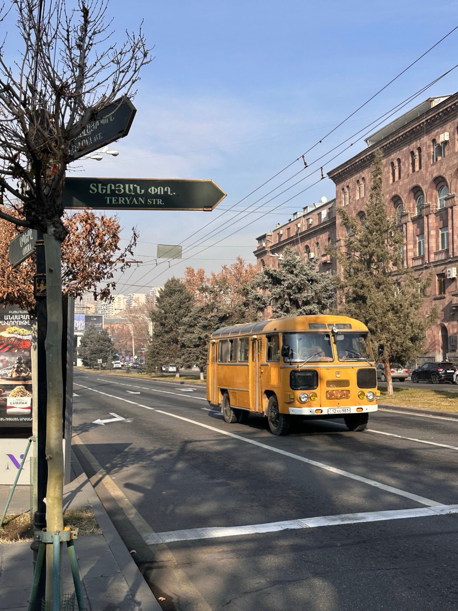 Vintage yellow Soviet-era bus on Teryan Street in Yerevan, Armenia — marshrutka guide