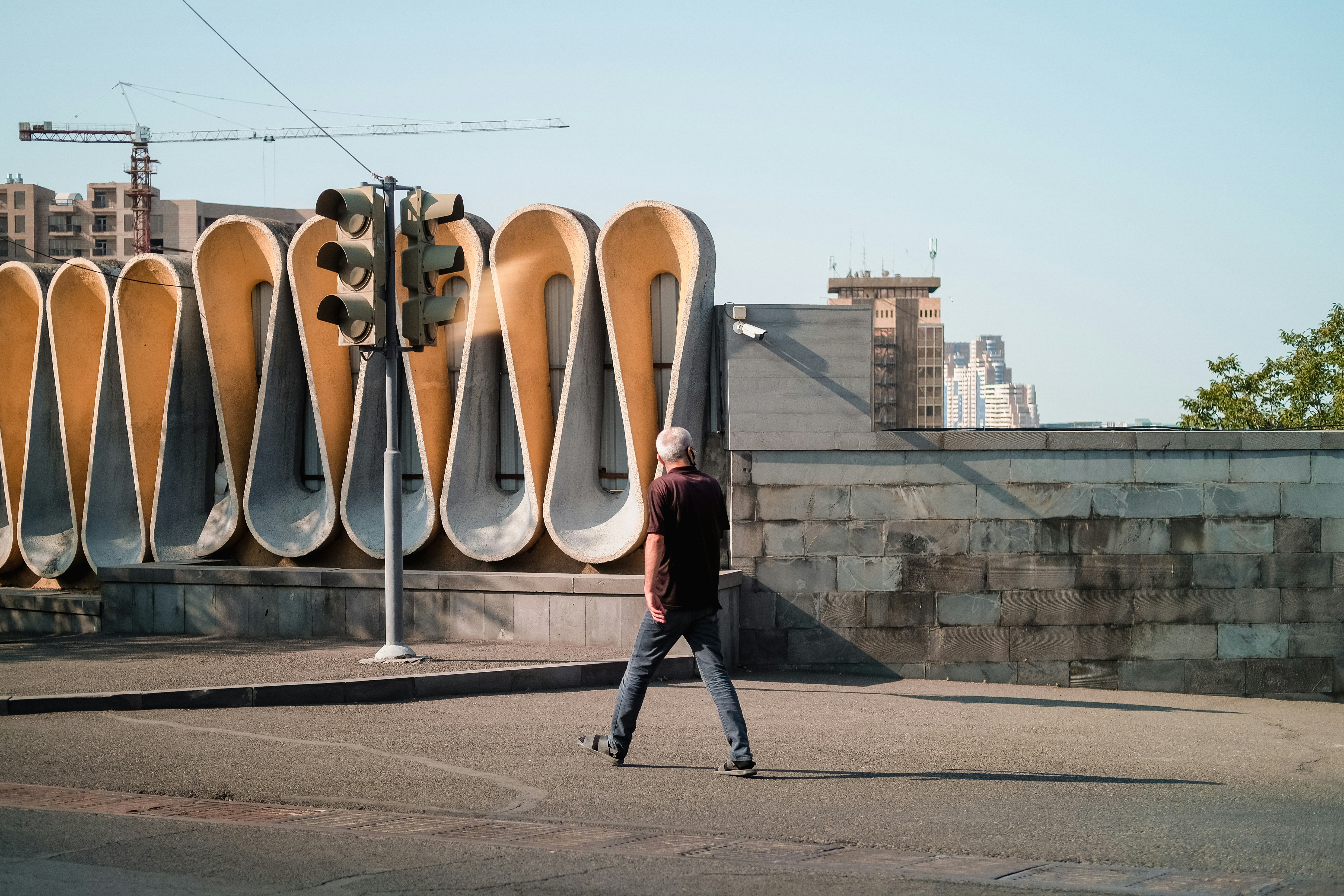 Solo traveller walking past the Cascade sculptural fountains in Yerevan, Armenia