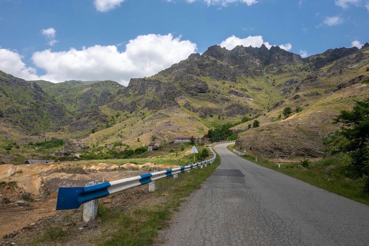 Winding mountain road with blue and white guardrails through the Armenian highlands near Alaverdi