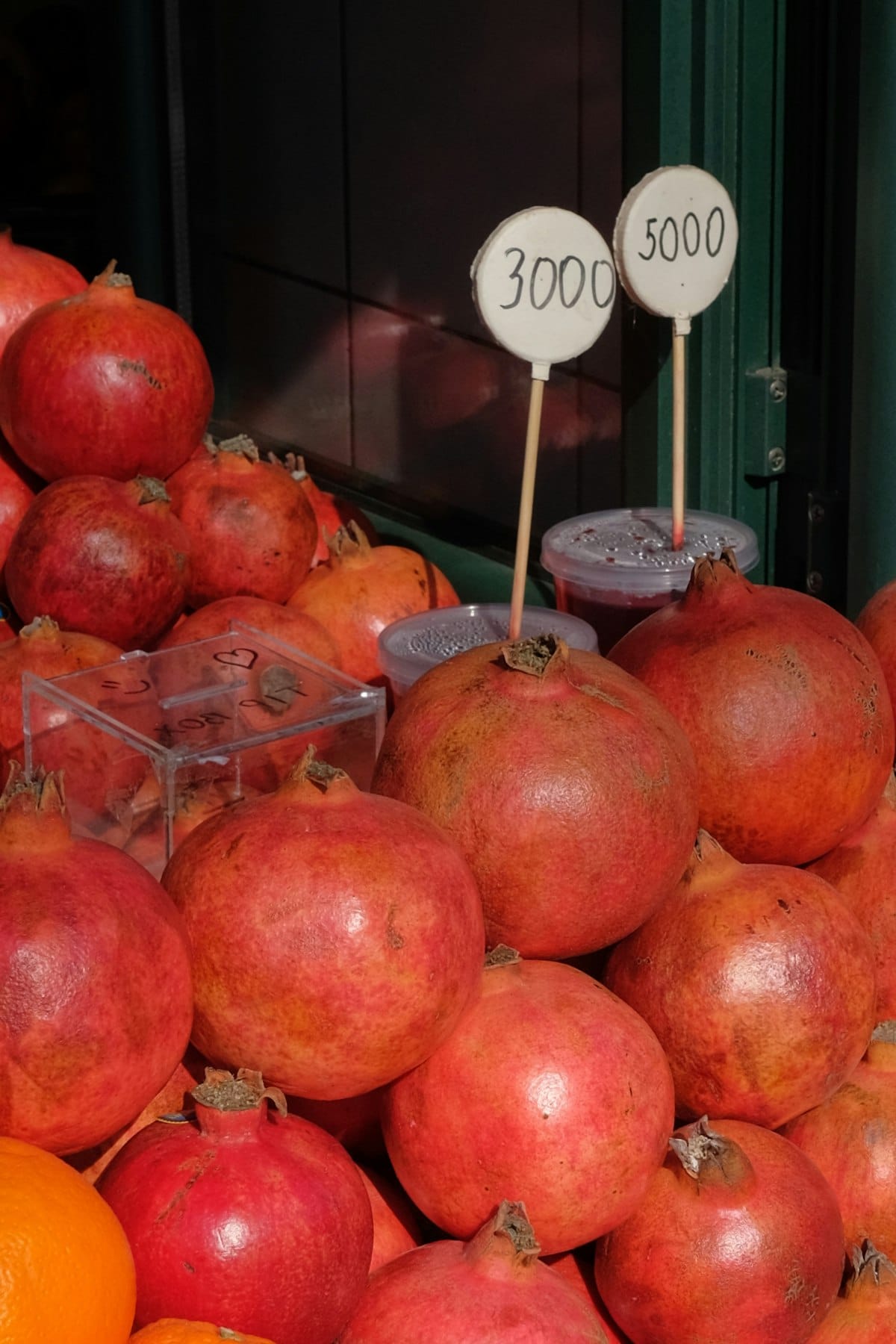 Fresh pomegranates piled high at a street market stall in Yerevan, Armenia