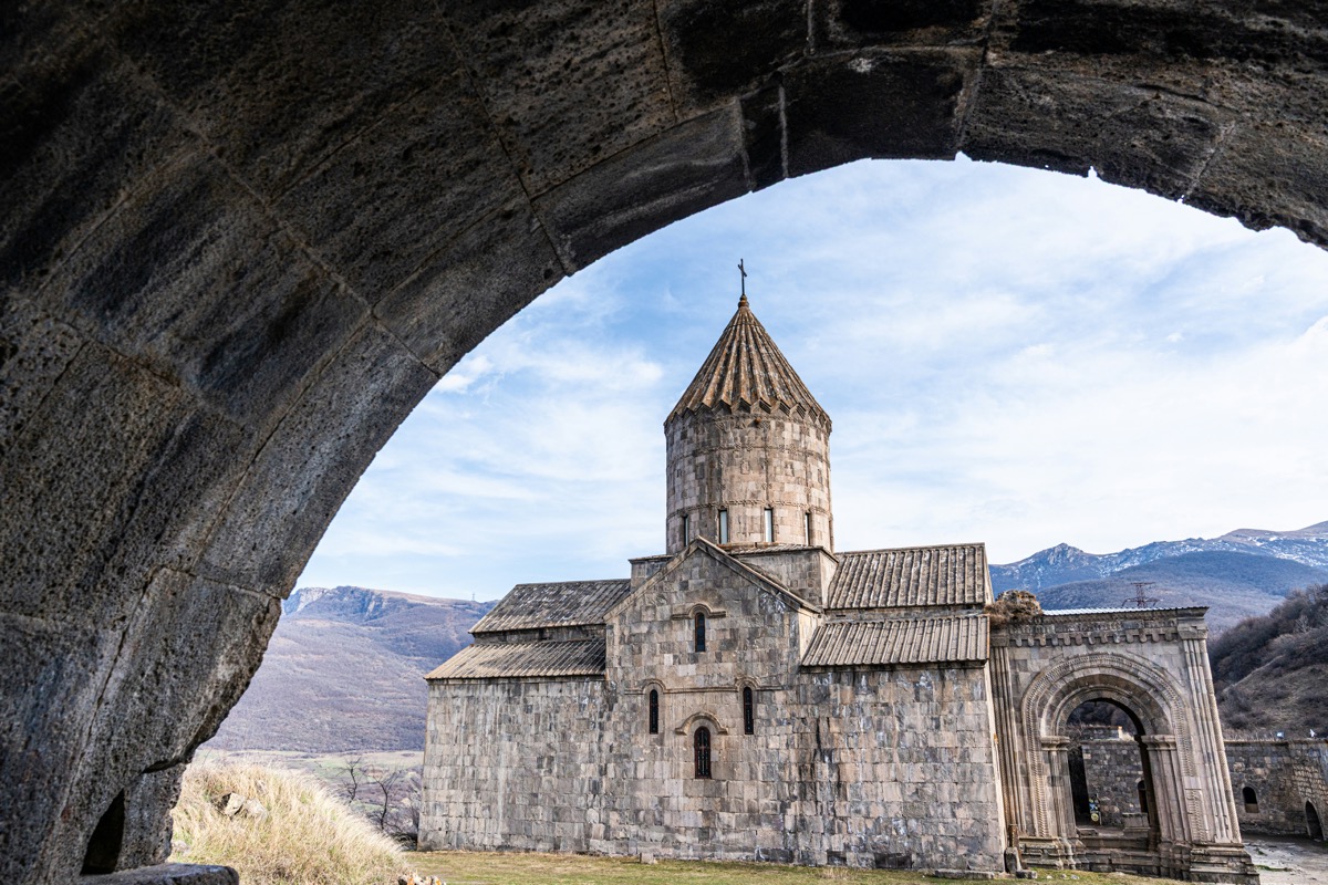 Tatev Monastery framed through a stone archway in south Armenia